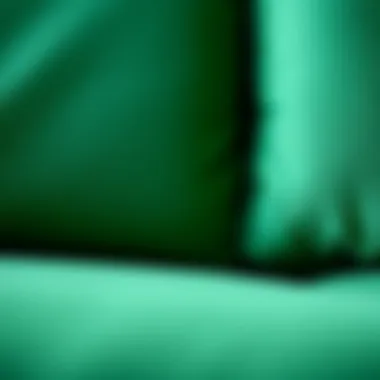 Close-up of the lush texture of an emerald green L sofa upholstery